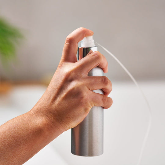 The optional pump cap being used to express liquid from the aluminium bottle.