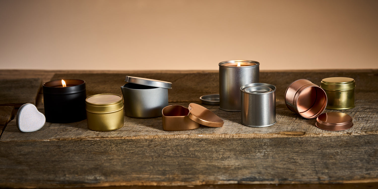 candle tins on a dark wood